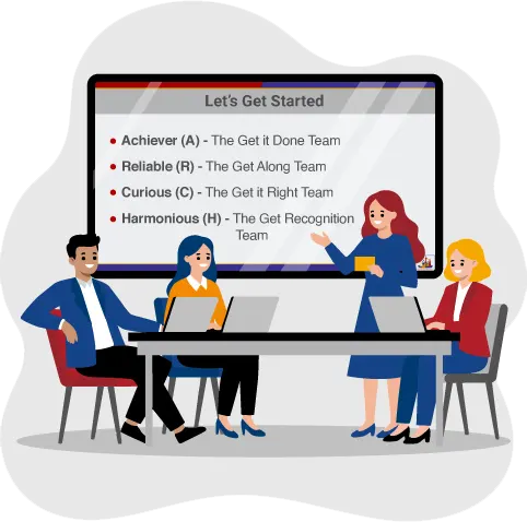 An instructor is standing beside an easel, teaching two people who are sitting at a desk with laptops on it